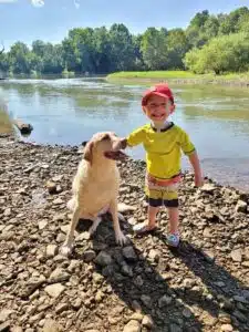 Cardinal Glennon kid Barrett with his dog at the river