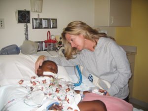 Ryan Smith in a hospital bed with Julie Keeley at his side