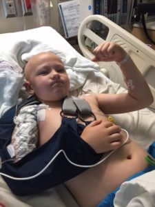 Alec Ingram flexing his muscles while at SSM Health Cardinal Glennon Children's Hospital