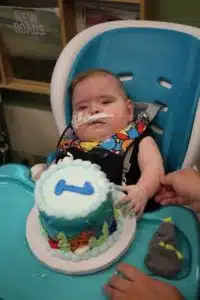 Cardinal Glennon kid Liam Rhoades on first birthday with birthday cake