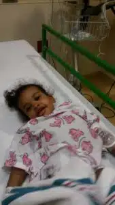 Cardinal Glennon kid Faith lying in hospital bed