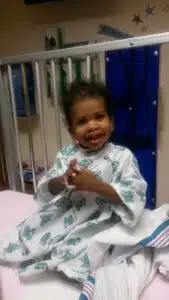 Cardinal Glennon kid Faith sitting up in hospital bed