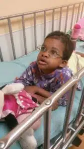 Cardinal Glennon kid Faith sitting in hospital bed