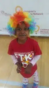 Cardinal Glennon kid Faith in a wig at CMN event