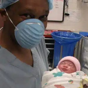 Cardinal Glennon kid Faith as baby held by her father