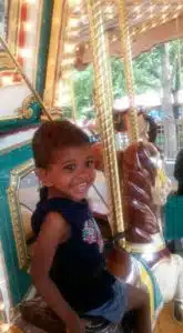 Cardinal Glennon kid Faith riding a carousel