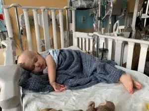 Ollie in a crib bed at SSM Health Cardinal Glennon Children's Hospital during treatment for his cancer