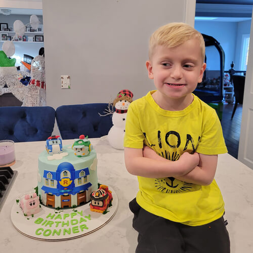 Glennon Kid Conner sitting next to his birthday cake in 2022