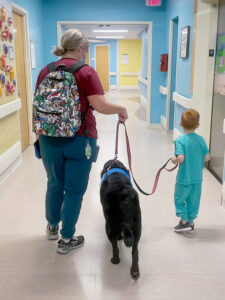 Beckett walking with therapy dog Thor