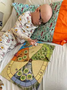 Beckett - inpatient cancer treatment, playing board game on hospital bed