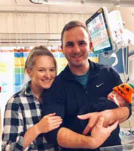 Easton held by dad with mom