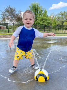 Easton playing in water sprinkler