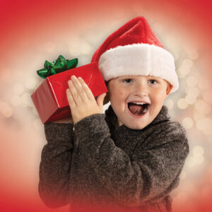 Cardinal Glennon kid, Liam - red background wearing Santa hat and holding a present