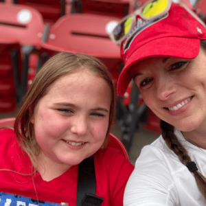 Libby with her mom at a baseball game