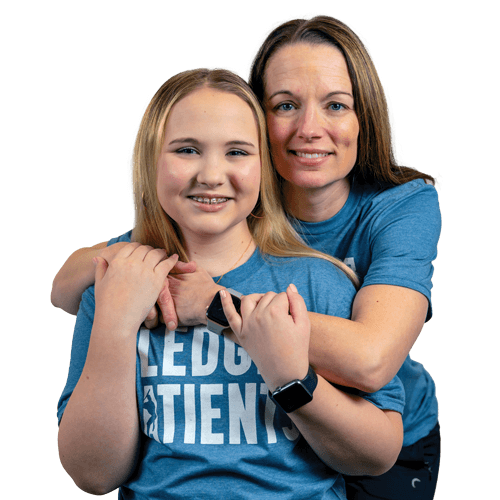 Homers for Health patient co-chair, Libby with mom, Michelle wearing their blue Pledge for Patients t-shirts