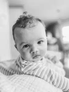 Chase - black and white portrait on tummy looking at camera