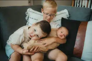 Chase - at home being held by brothers on the couch