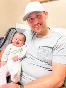 Chase - held by dad in hospital smiling
