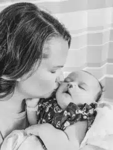 Chase - black and white, mom kissing cheek while holding in hospital