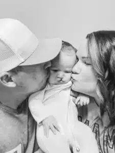 Chase - black and white, mom and dad kissing cheeks pre-surgery