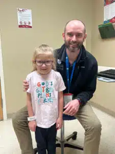 Kenzie - posing with physician at Cardinal Glennon clinic