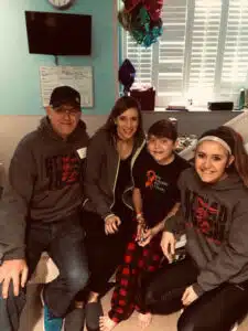Logan - posing with family in in-patient cancer room