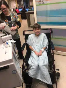 Logan - admitted to the Emergency Department, smiling in a wheelchair