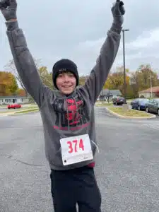Logan - hands in air after running a race