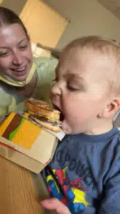 Easton - eating a cheeseburger in hospital room