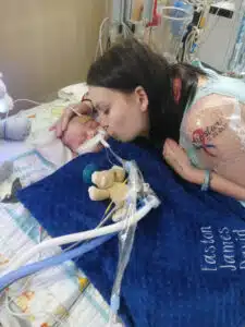 Easton - sleeping in hospital bed, kissed by mom