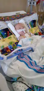 Easton - sleeping in PICU bed with ventilator tubes