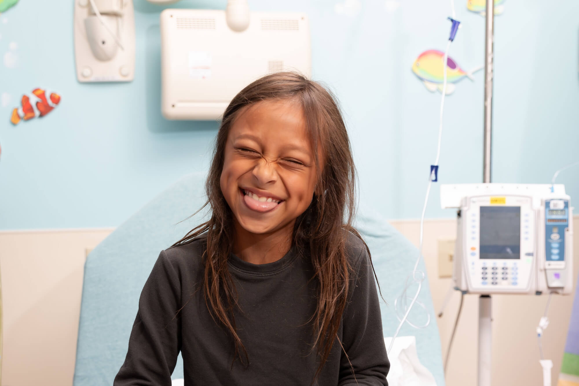 IVIG patient smiling with tongue sticking out playfully