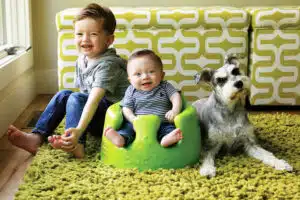 portrait - Colten in Bumbo seat with brother, Benjamin and family dog
