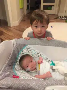 Colten - receiving oxygen at home with big brother, Benjamin looking over