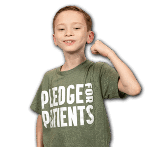 Colten flexing his arm in a Pledge for Patients t-shirt