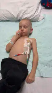 Wyatt resting in his hospital bed with his port