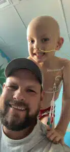 Wyatt on his dad's shoulders inside his hospital room