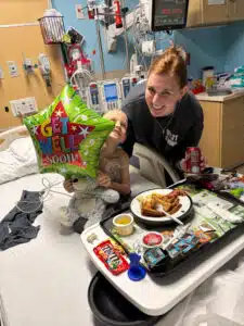 Wyatt and mom with a "Get Well Soon" balloon