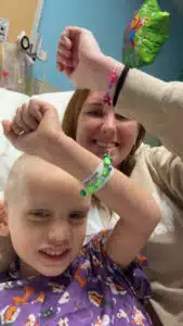 Wyatt and his mom showing their bead bracelets in the 4North inpatient cancer unit