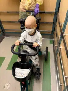Wyatt riding a special tricycle inside Cardinal Glennon
