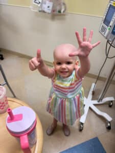 Cardinal Glennon patient Bristol holding up 6 fingers inside the Costas Center