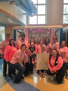 Bristol's crew of friends and family posing for a group photo at her "Last Chemo" bell ceremony