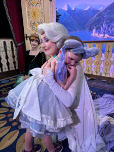 Cardinal Glennon patient Bristol at Disney World hugging Elsa from Frozen
