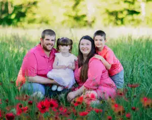 Horner family portrait in a field with flowers in the foreground