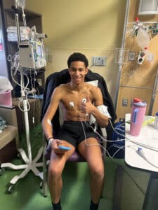 Quincy recovering in the PICU sitting up in a chair