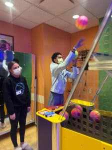 Quincy and his girlfriend playing a basketball arcade game at Warner's Corner in Cardinal Glennon