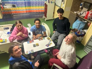 Quincy's friends visiting him in his hospital room at Cardinal Glennon playing cards