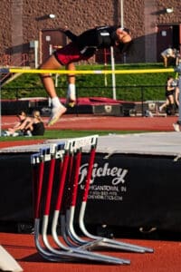 Quincy performing the high jump at track and field