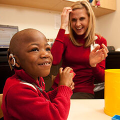 Bryson May and an audiologist at SSM Health Cardinal Glennon