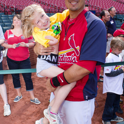 Patient Camryn Akerson visits Allen Craig on field in pre-game.